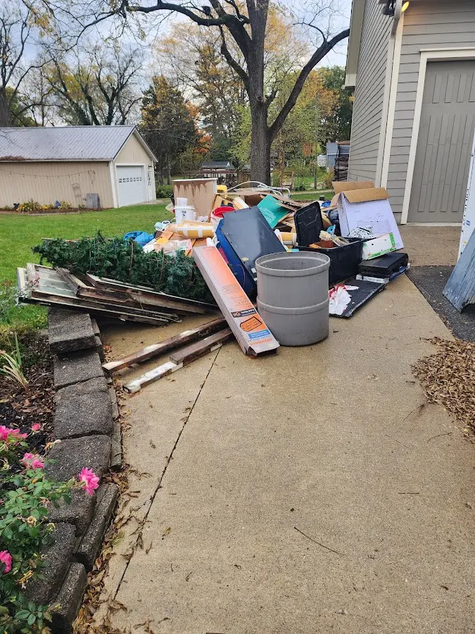 Dumpster being loaded with debris for 12 Yard Dumpster Rental in Rocky Mount